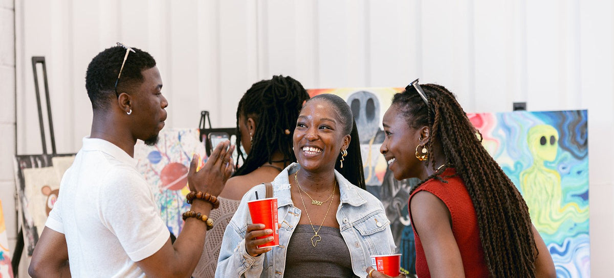 Group of people conversing at BlackOwned Studios event